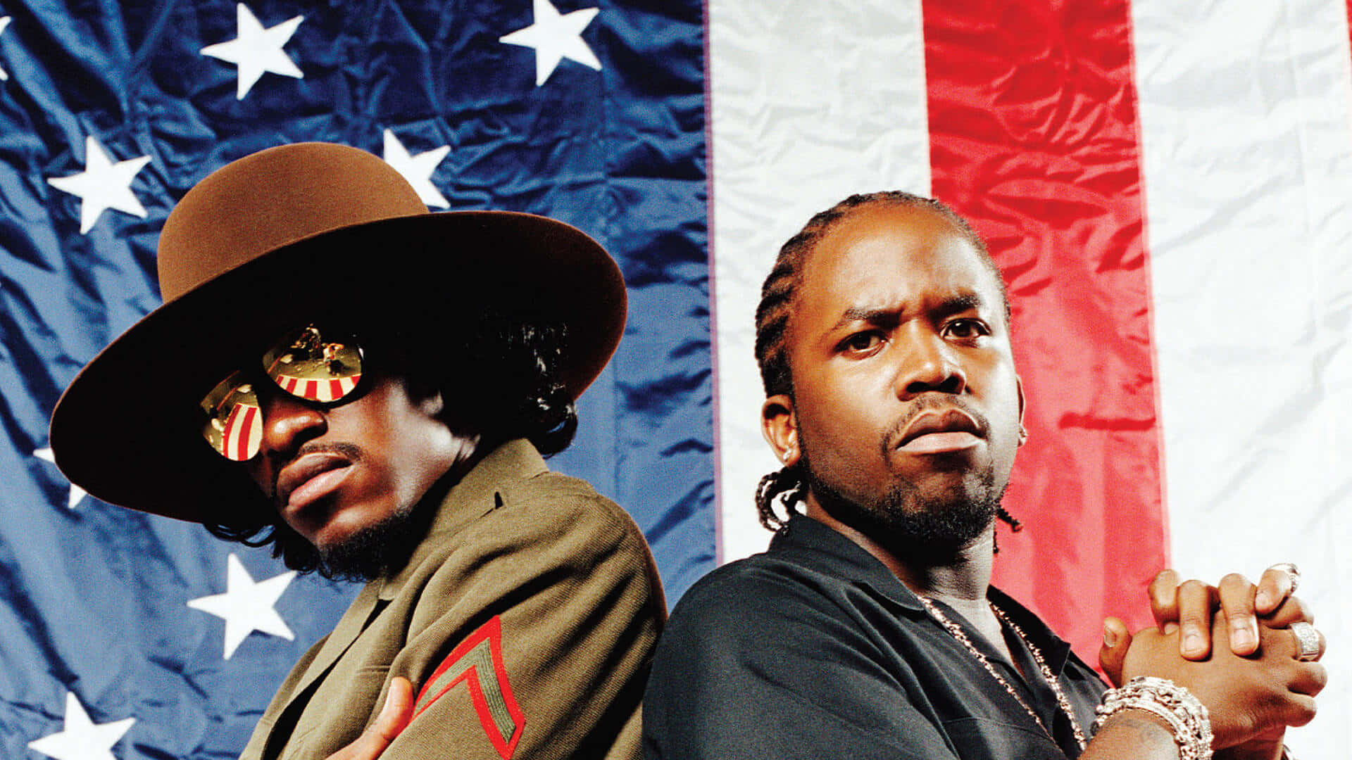Big Boiand Andre3000 Against Flag Background Wallpaper