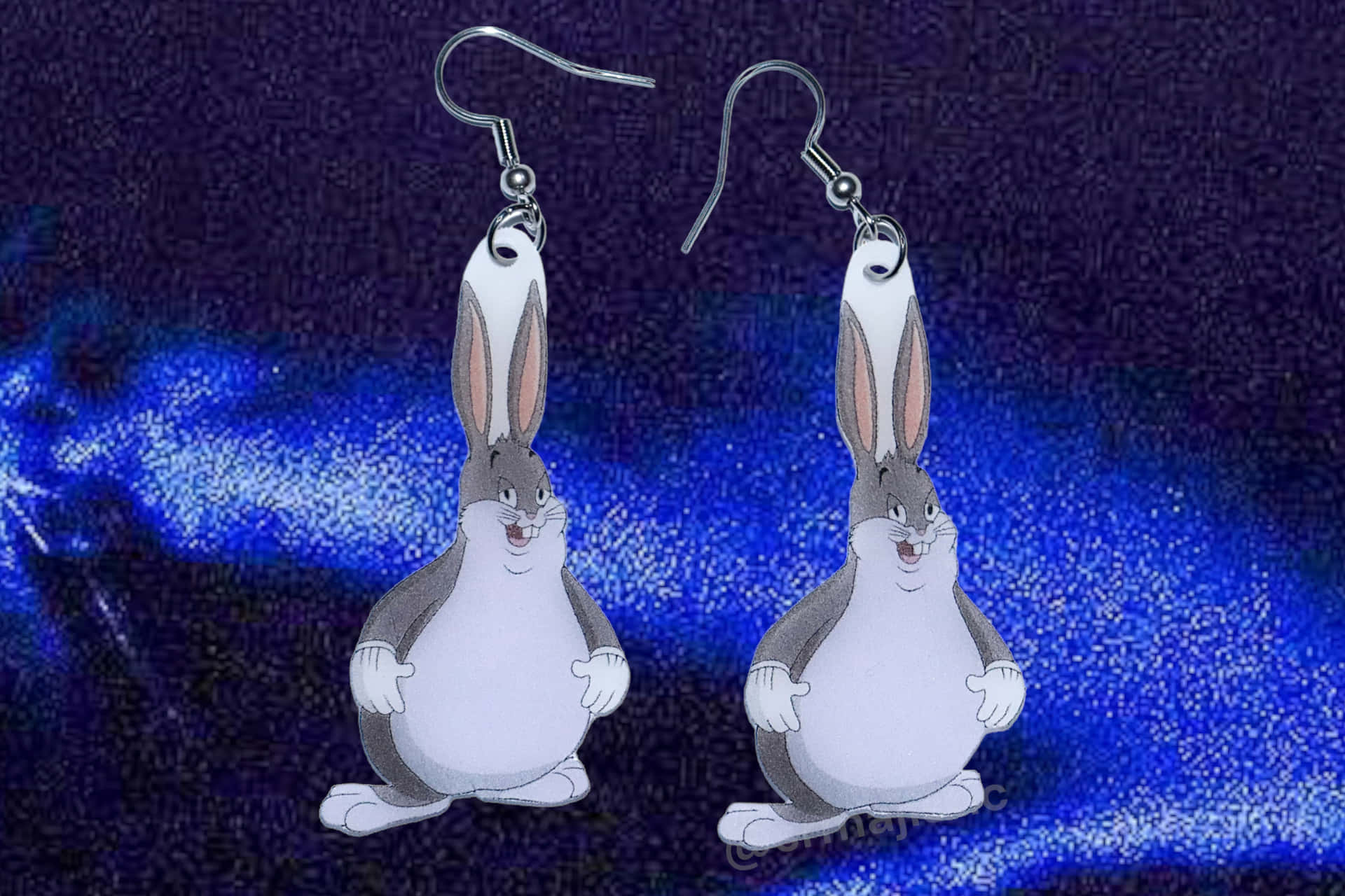 Download A Pair Of Cartoon Rabbit Earrings On A Blue Background 