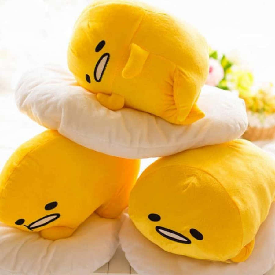 A Stack Of Yellow Stuffed Animals On Top Of Each Other Wallpaper