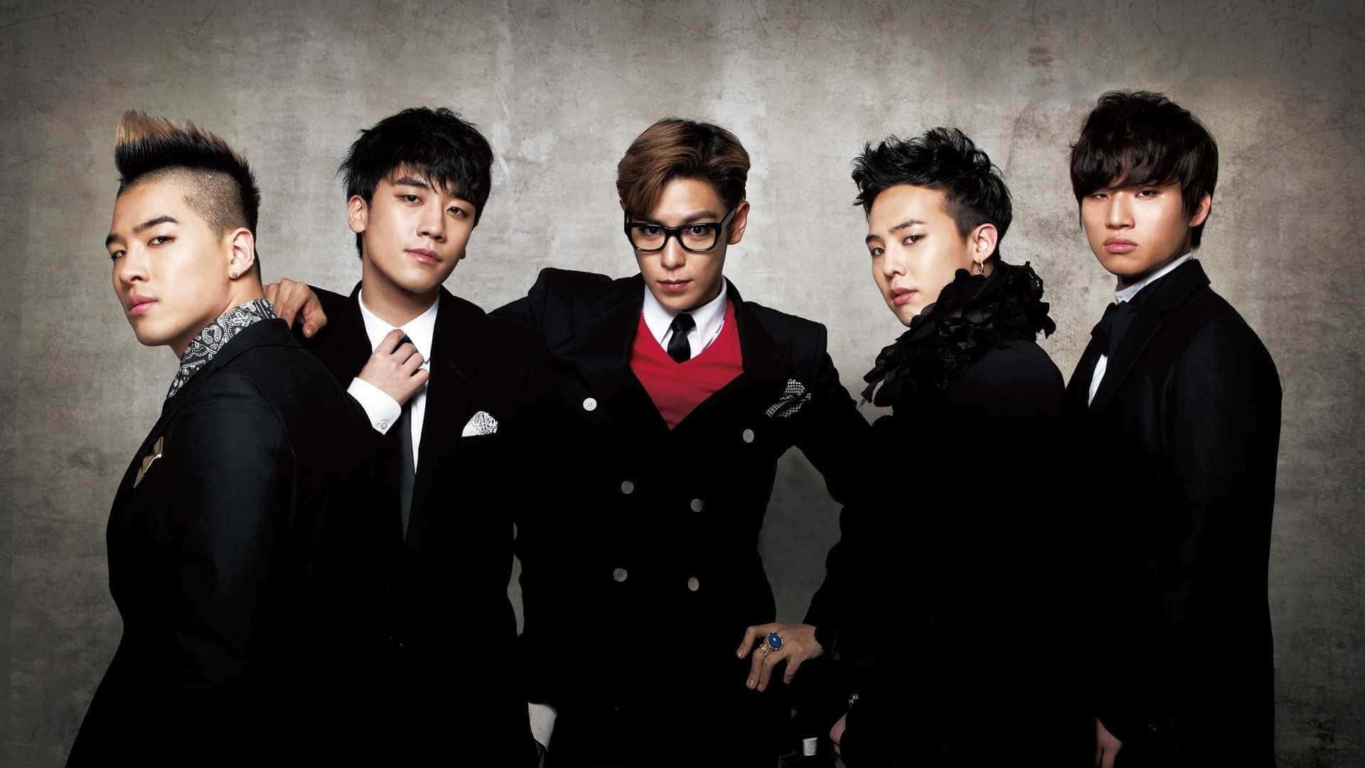 All 5 members of South Korean band Bigbang pose in the snow