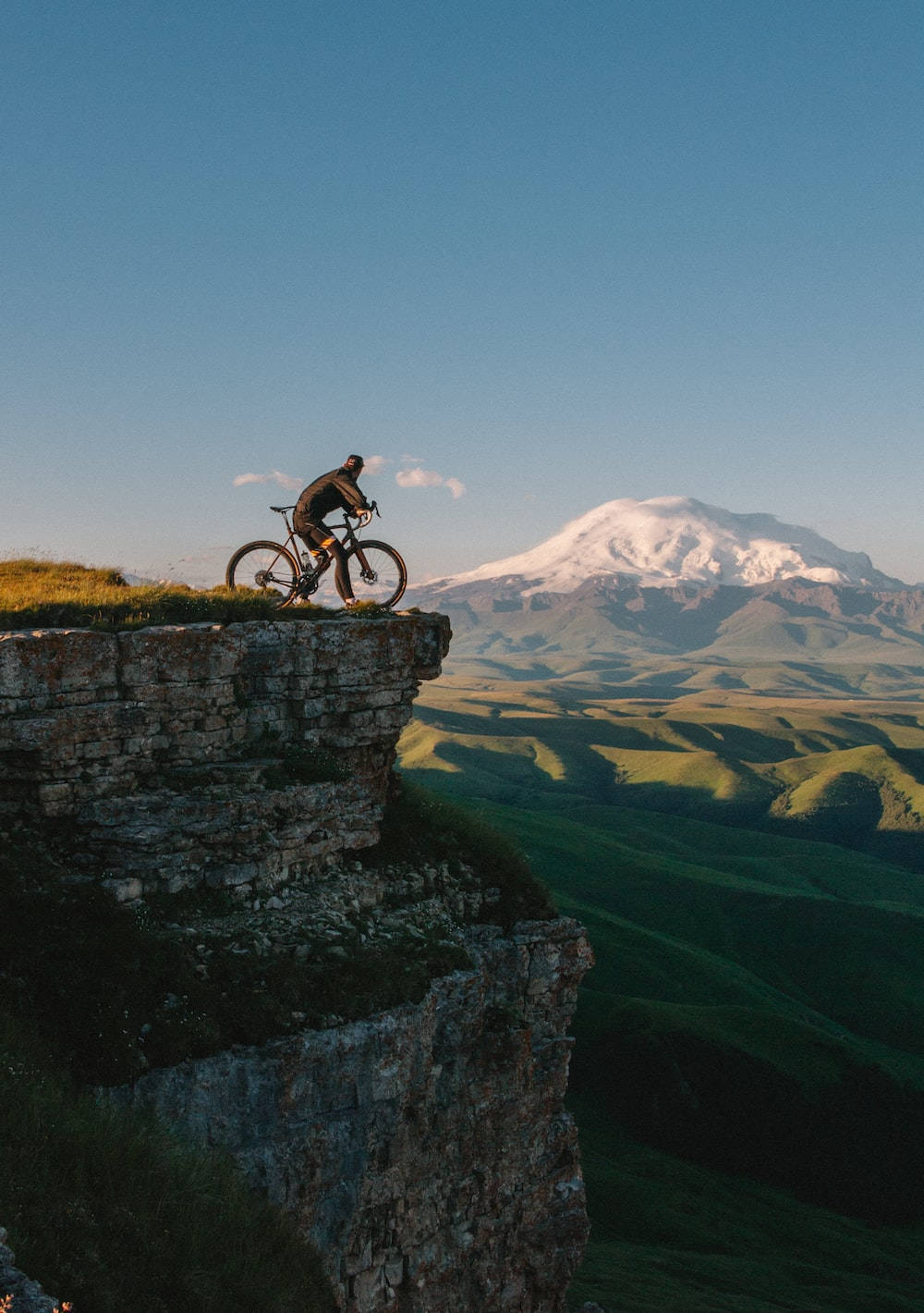 Bike Lover On A Cliff Background