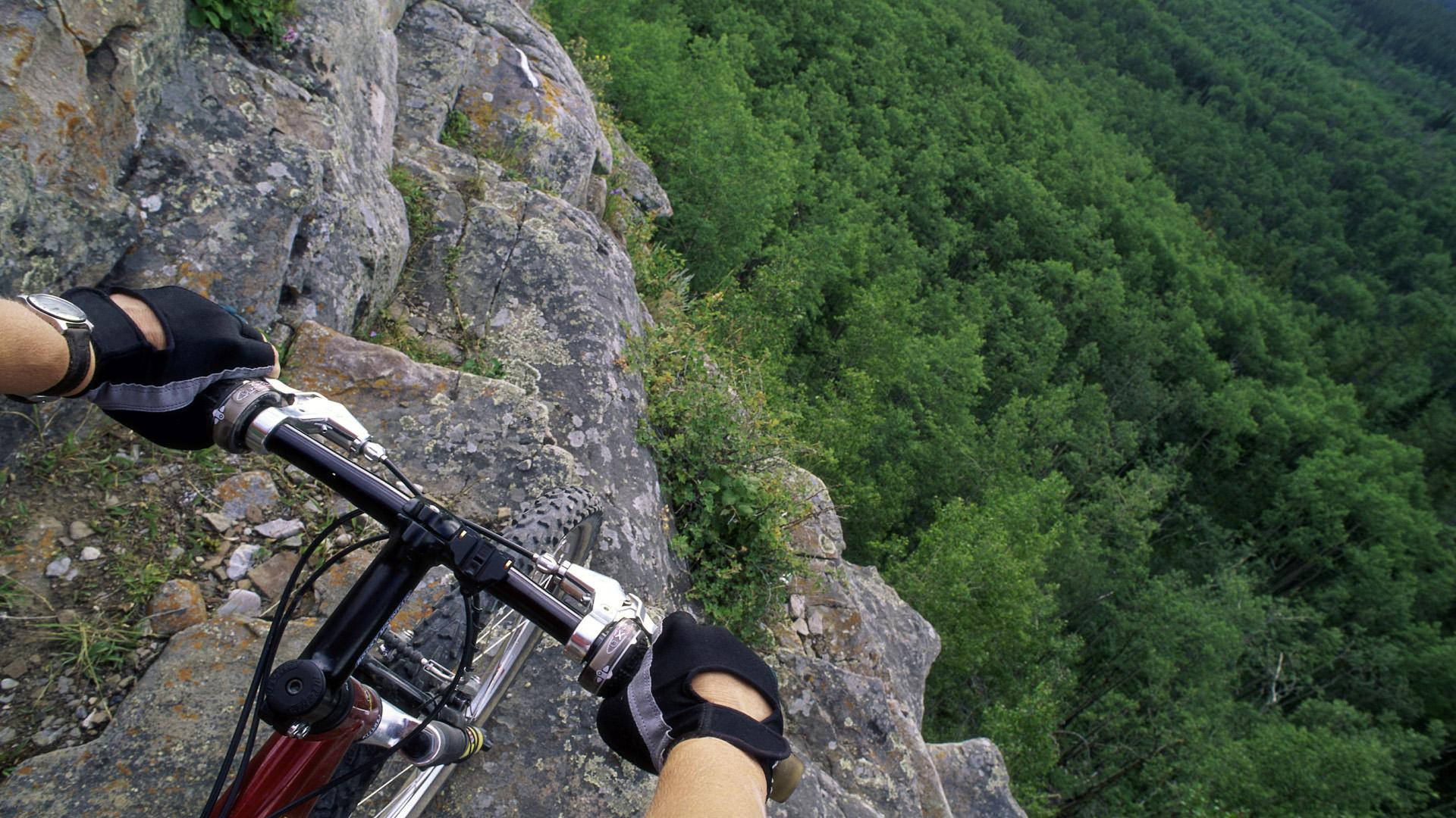 Bike Ride On Steep Cliff Wallpaper