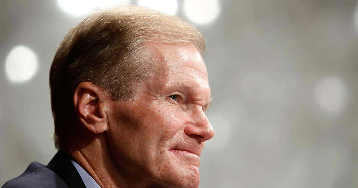 Bill Nelson Smiling With A Gray Backdrop Wallpaper