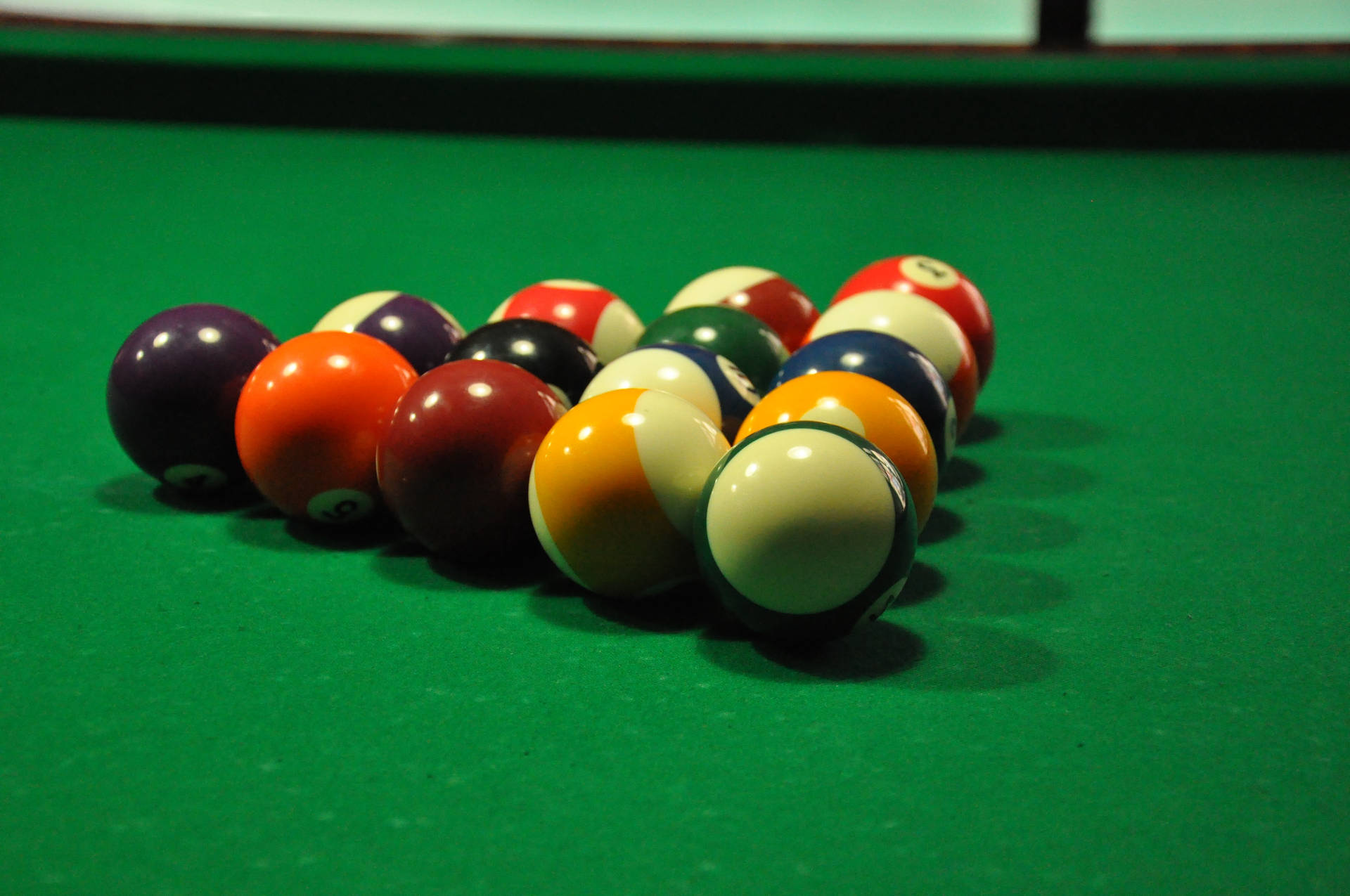 Captivating Shot of Billiard Balls in Triangle on the Pool Table Wallpaper