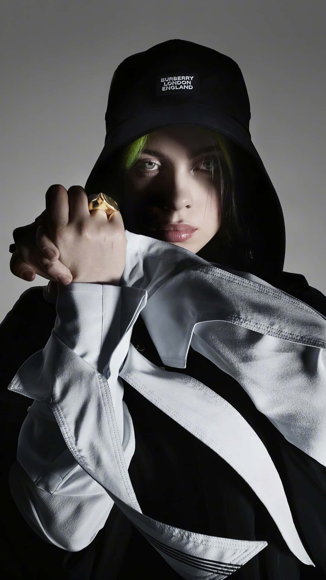 Singer/Songwriter Billie Eilish Smiles in Front of a Black and White Background