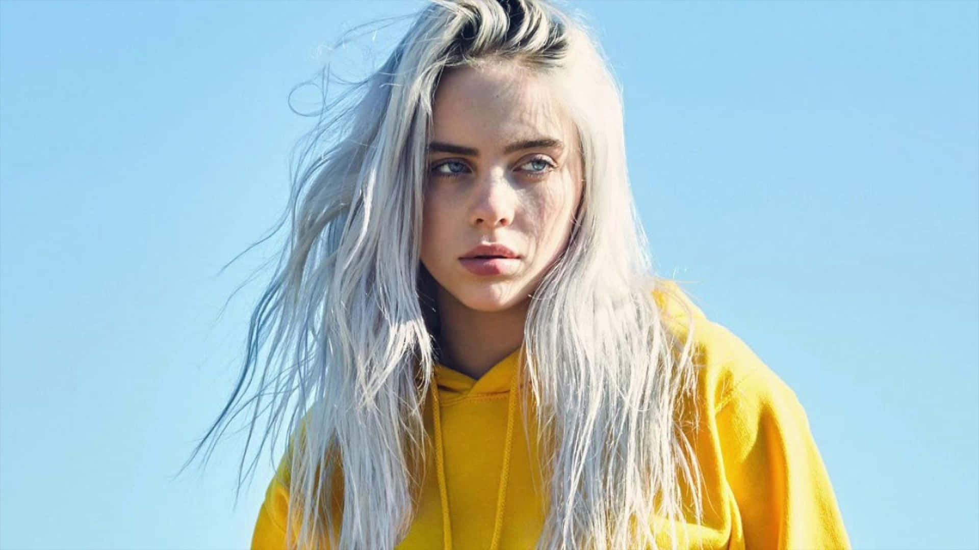 Billie Eilish poses with a laptop Wallpaper