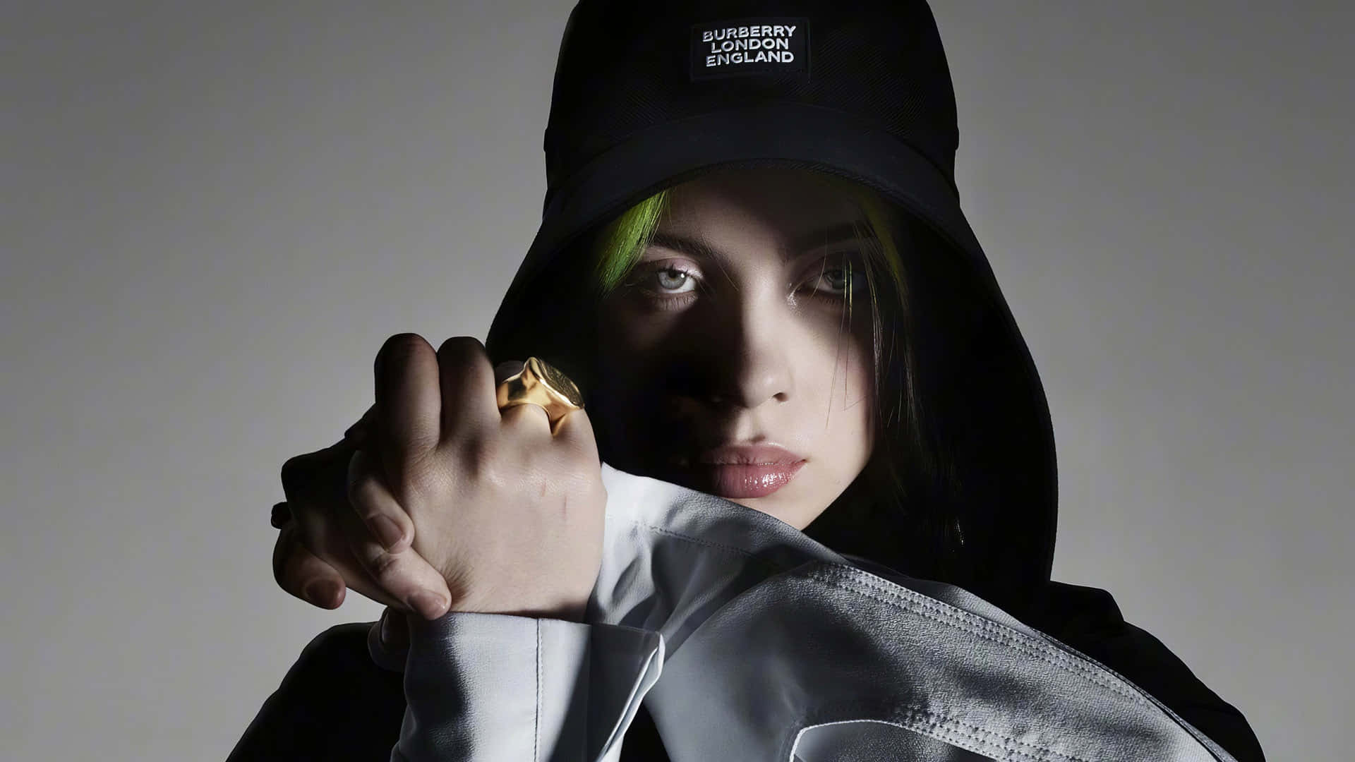 Girl Power! Billie Eilish stands with her laptop showing her influence and success. Wallpaper