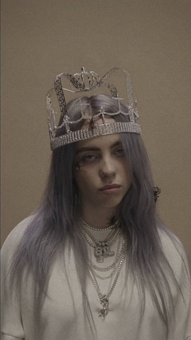 Billie Eilish looking up with a wistful expression Wallpaper