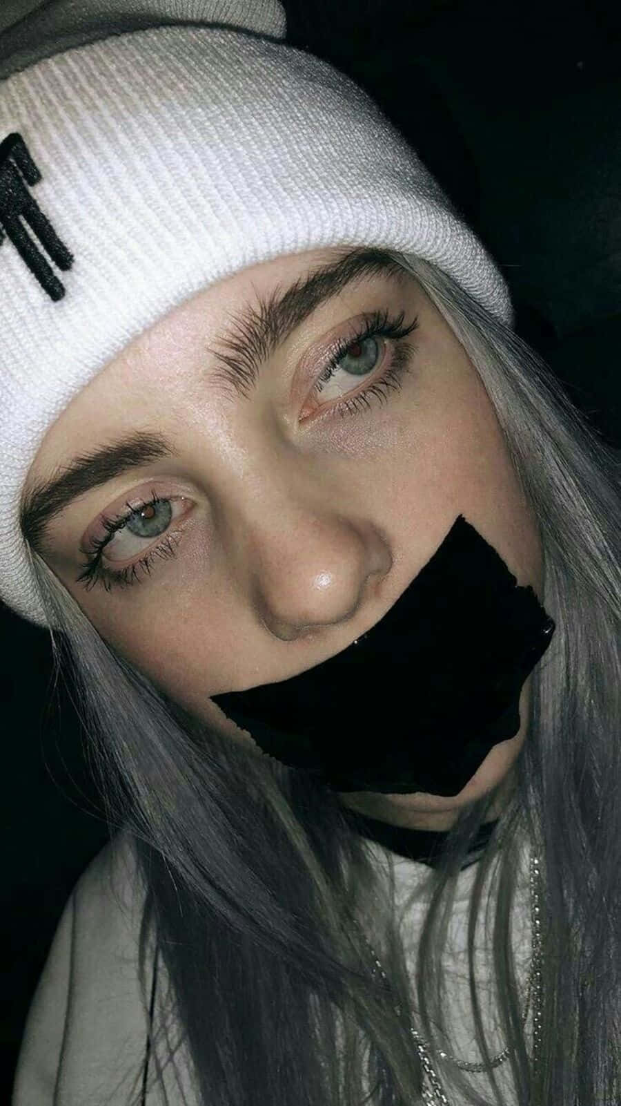 Billie Eilish Sad Expression With Tape Over Mouth Wallpaper