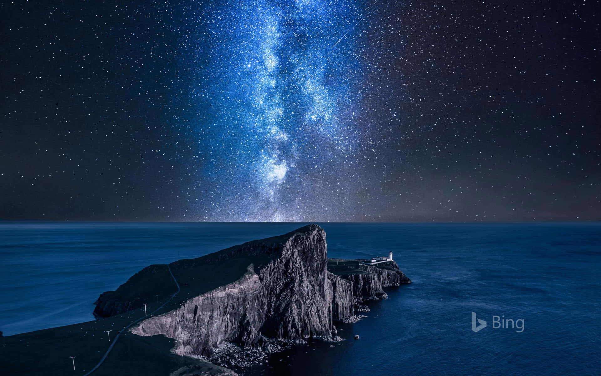 A Lighthouse And Milky Way Above The Ocean