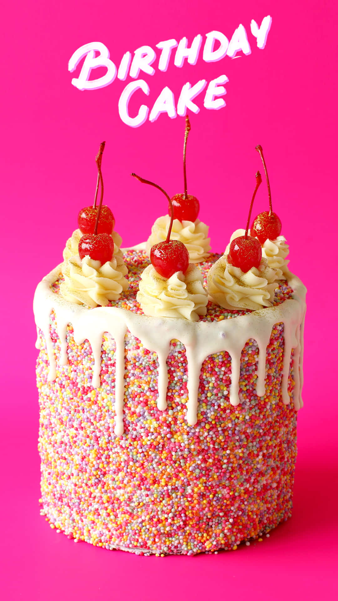 A Birthday Cake With Sprinkles And Cherries On A Pink Background