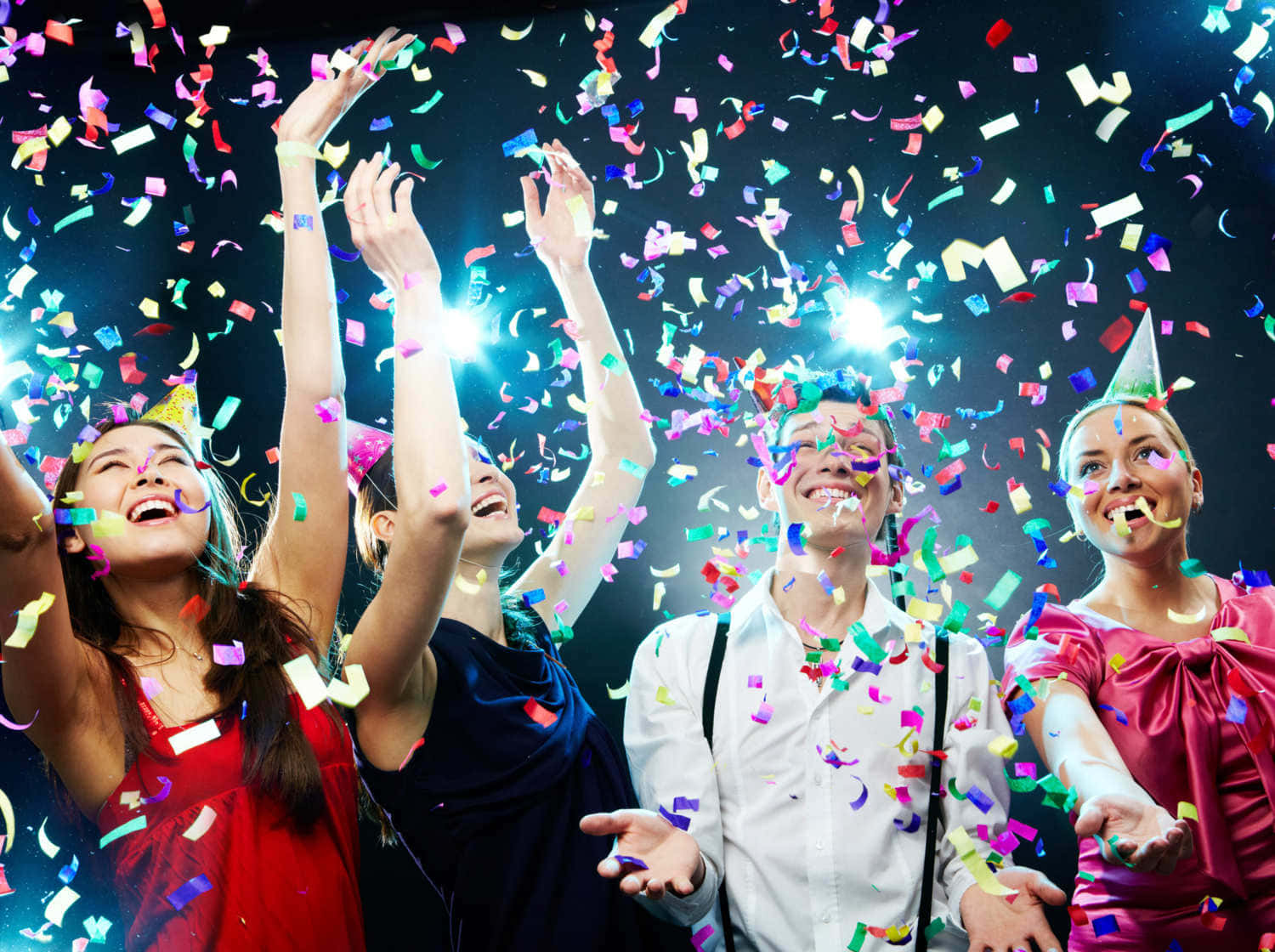 A Group Of People Celebrating A Party With Confetti