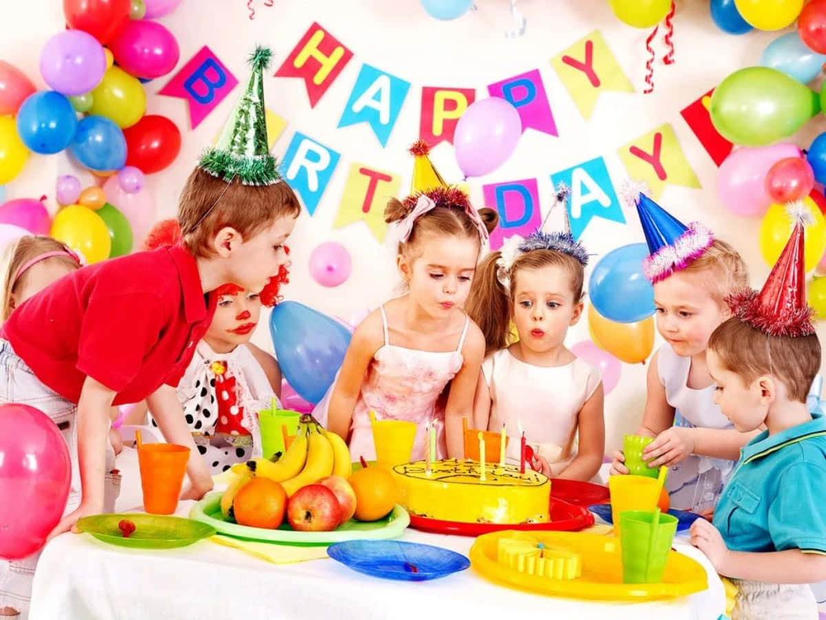 A group of smiling friends celebrating a birthday surrounded by fun and treats.