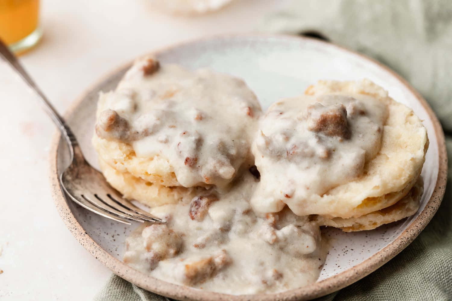 A Plate Of Biscuits With Gravy On It