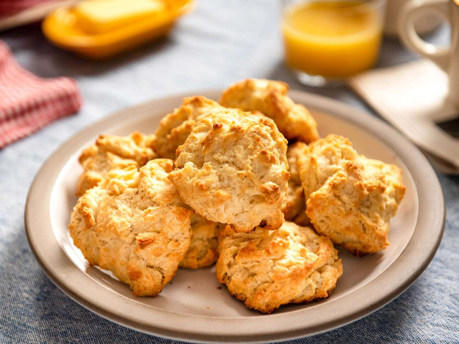 A Plate Of Biscuits With Orange Juice