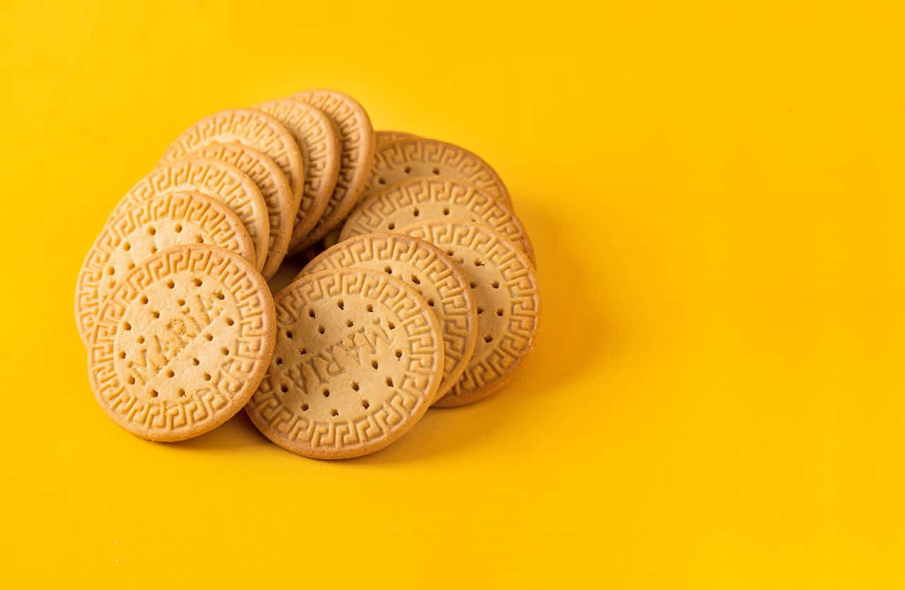A Pile Of Cookies On A Yellow Background