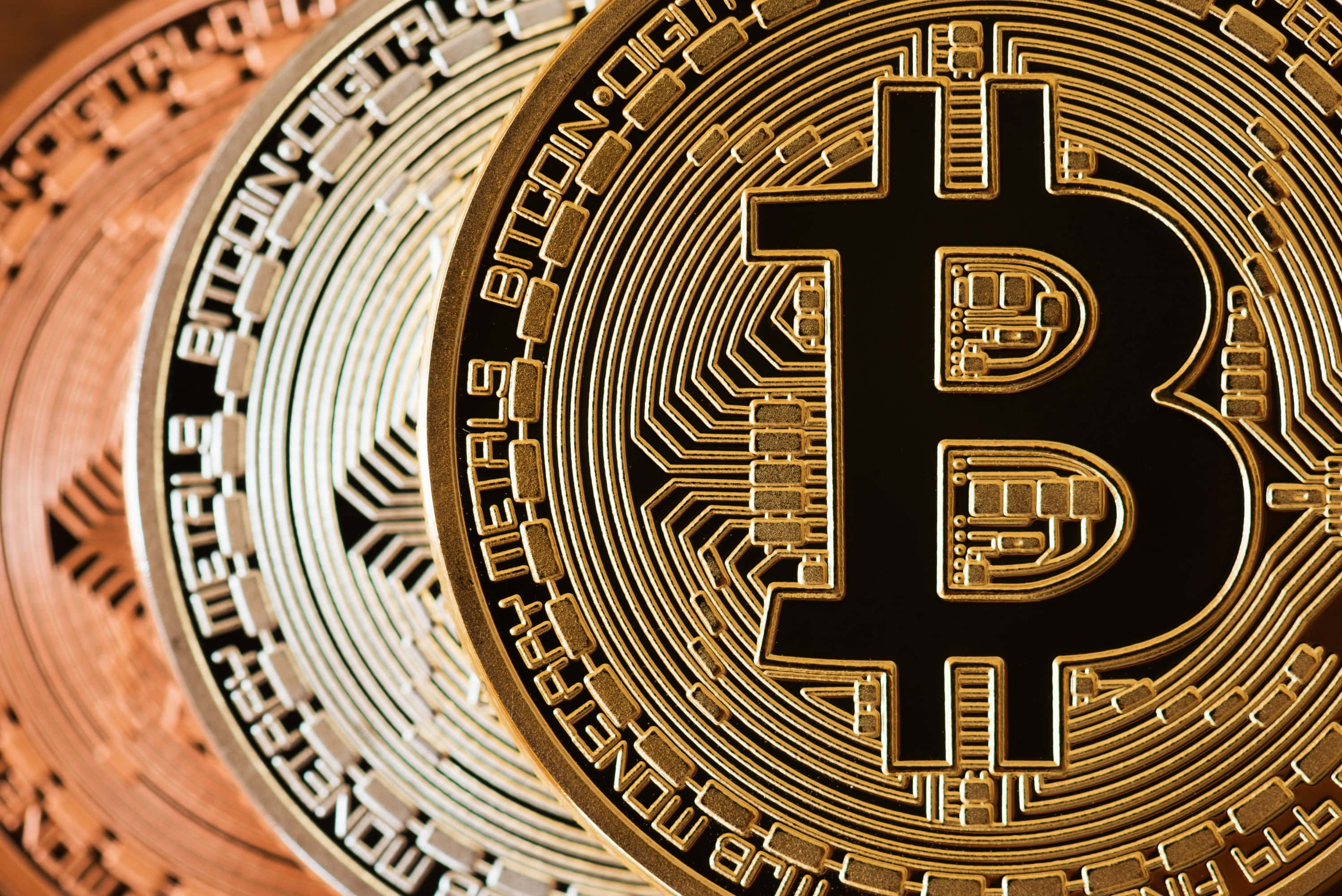 Bitcoins Are Shown In A Row On A Wooden Surface