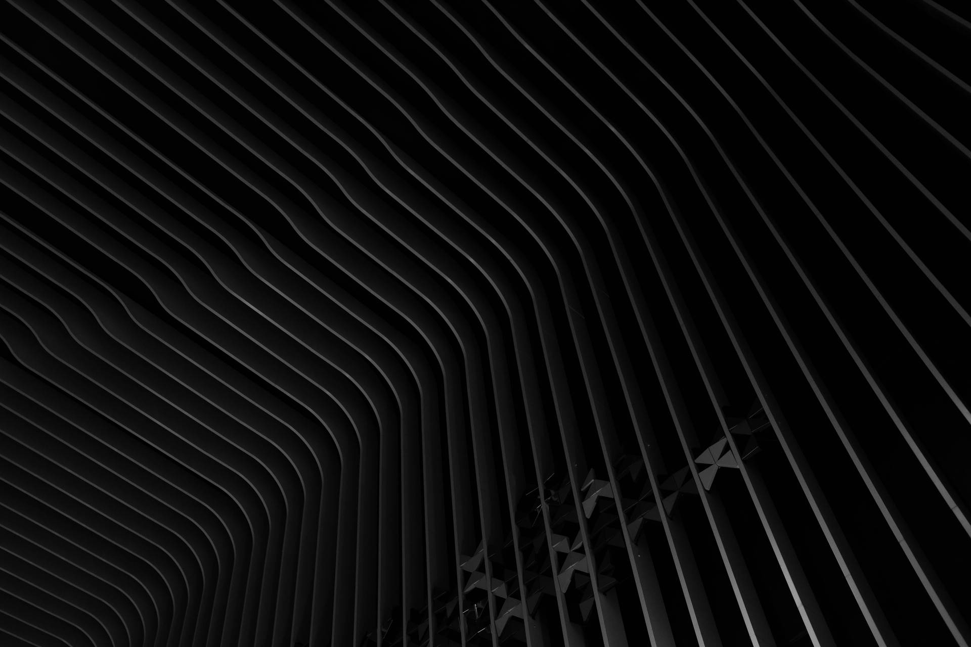 Caption: Sleek Black Abstract Metallic Stripes Wallpaper