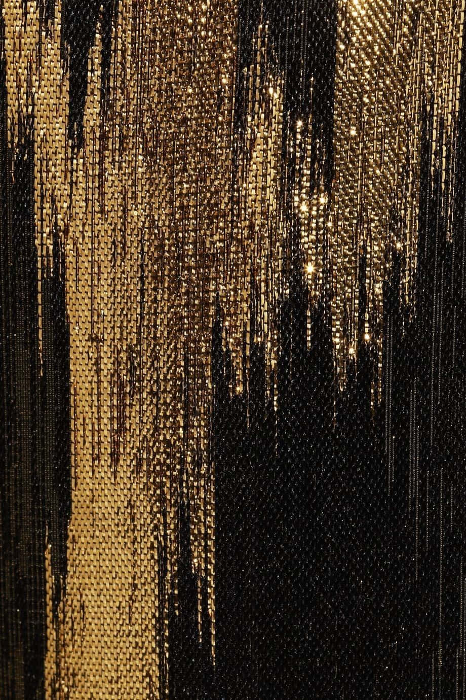 A Close Up Of A Black And Gold Sequin Dress Wallpaper