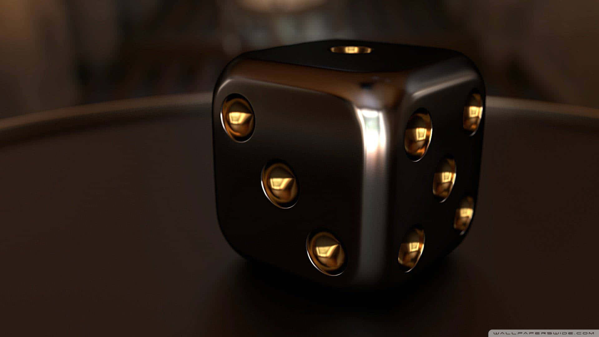 A Black And Gold Dice On A Table Wallpaper