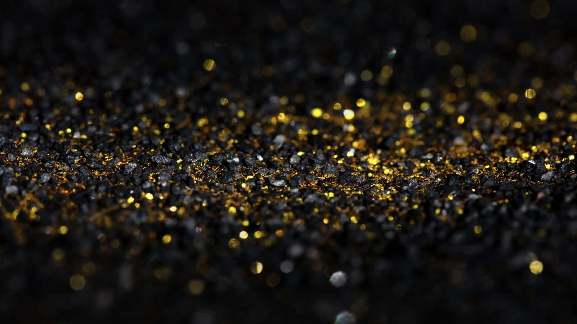 Particelledi Glitter Nero E Oro In Macro Sfondo