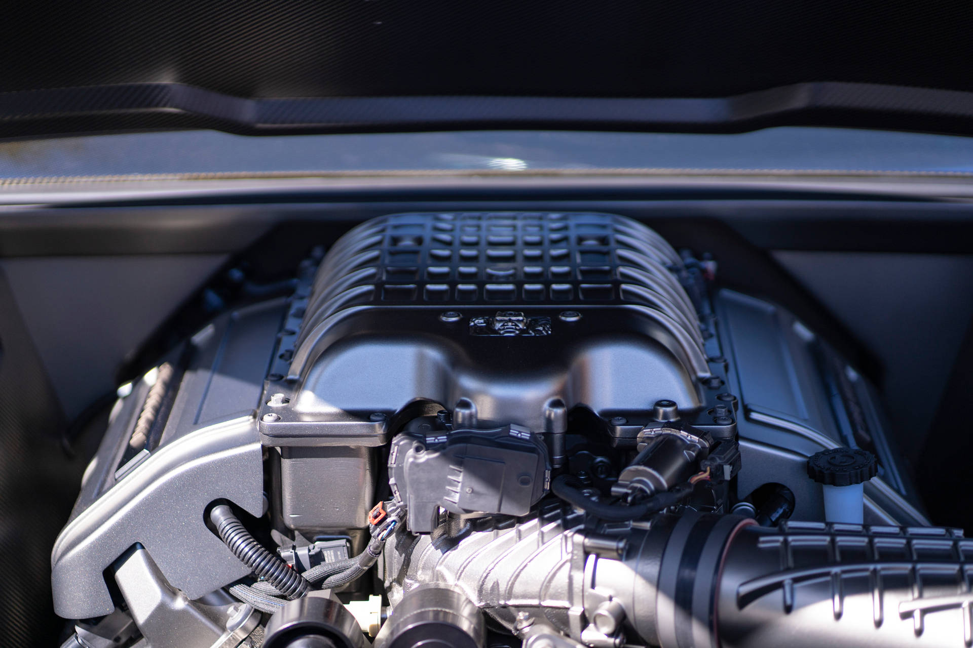 An Up-Close Look at a Black and Silver Car Engine Wallpaper