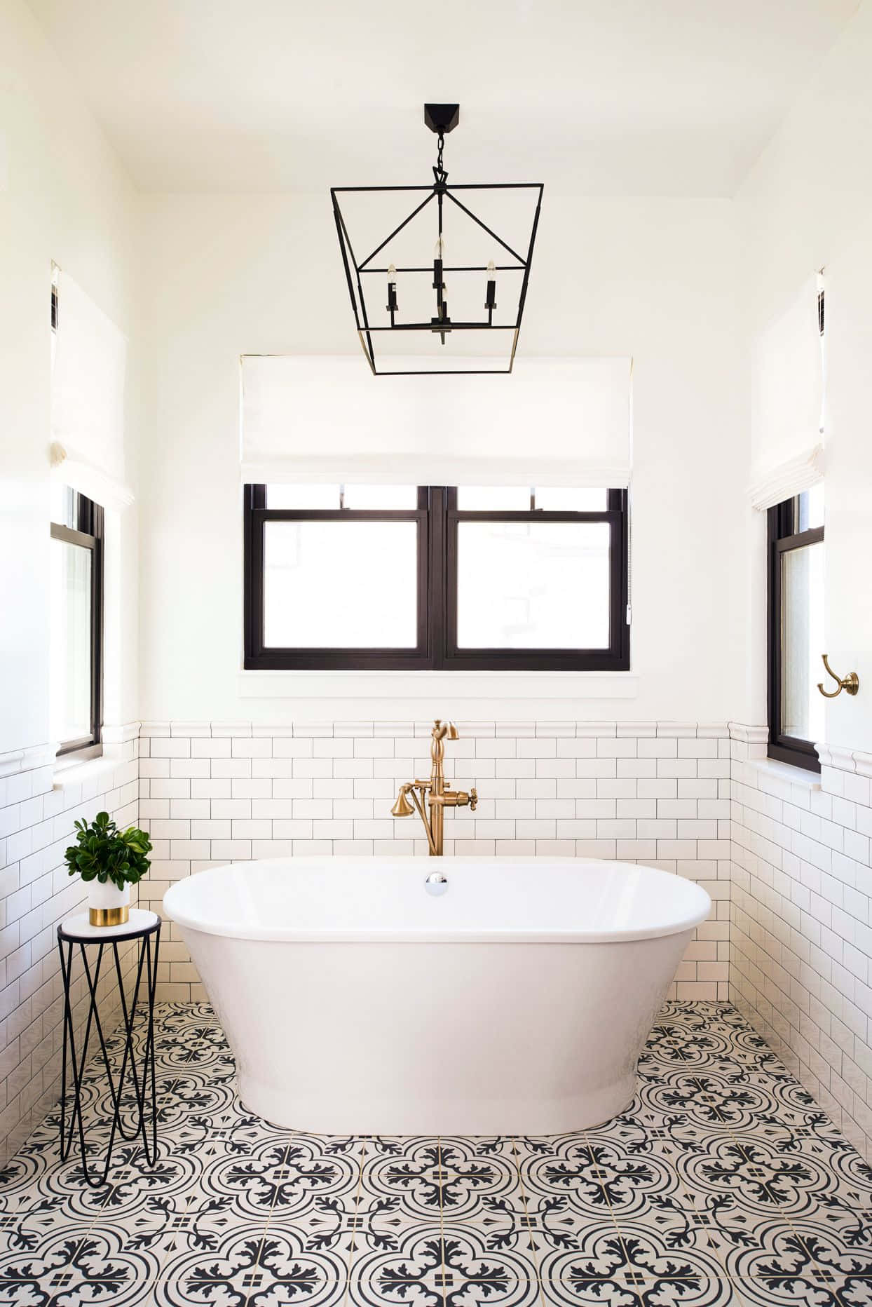 A Bathroom With Black And White Tiled Floors