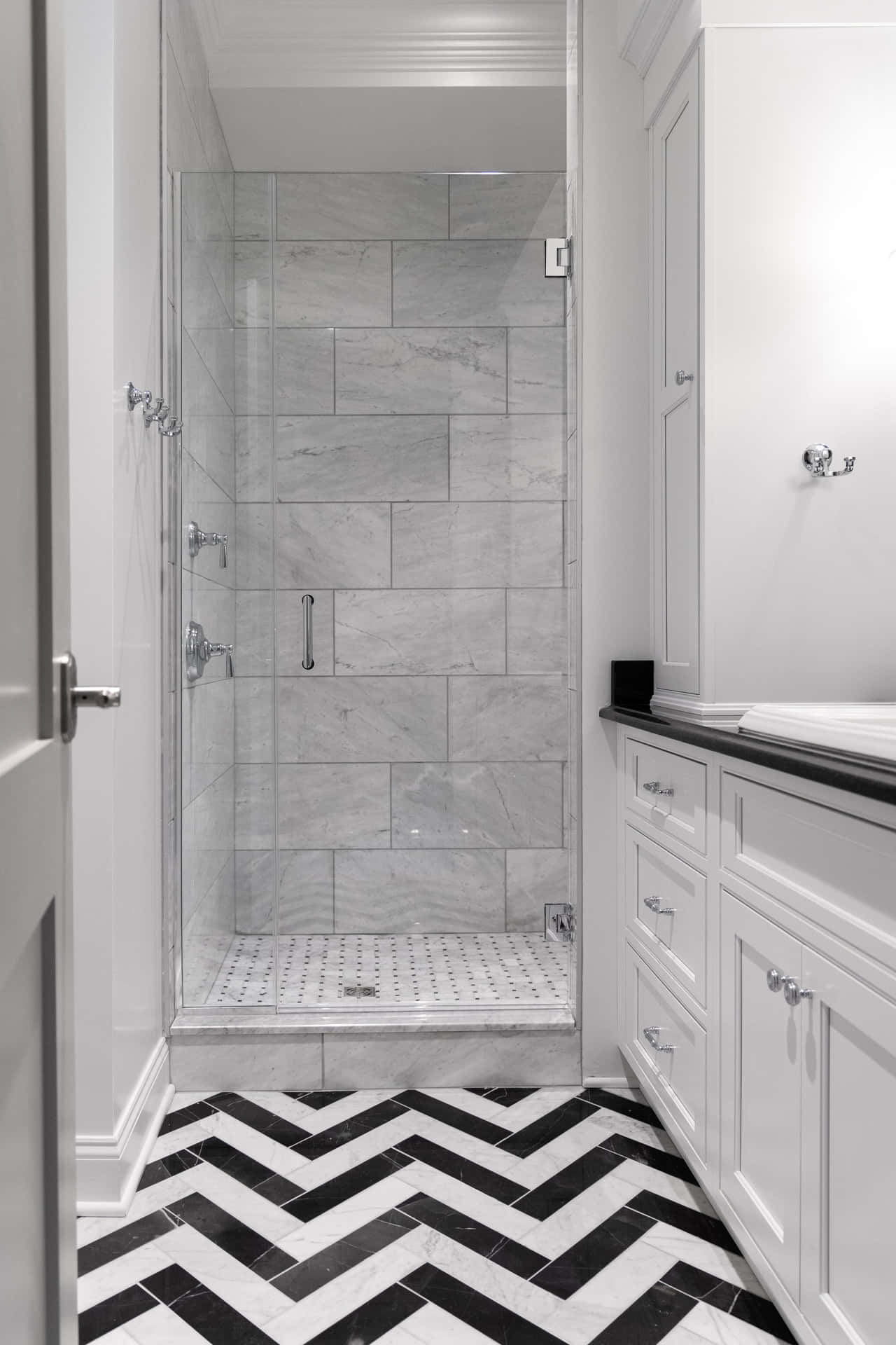 A Bathroom With A Black And White Chevron Floor