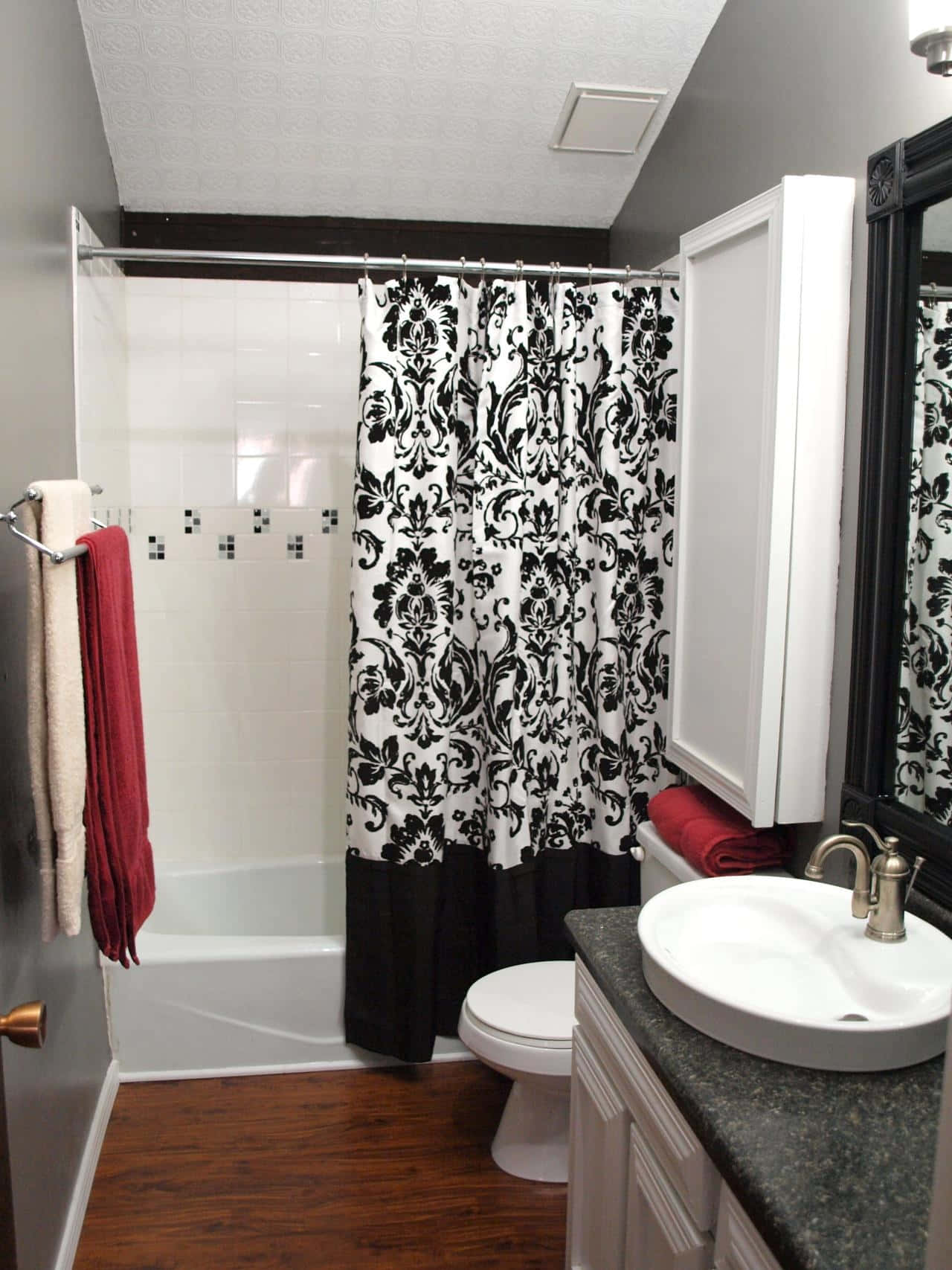A Bathroom With A Black And White Shower Curtain