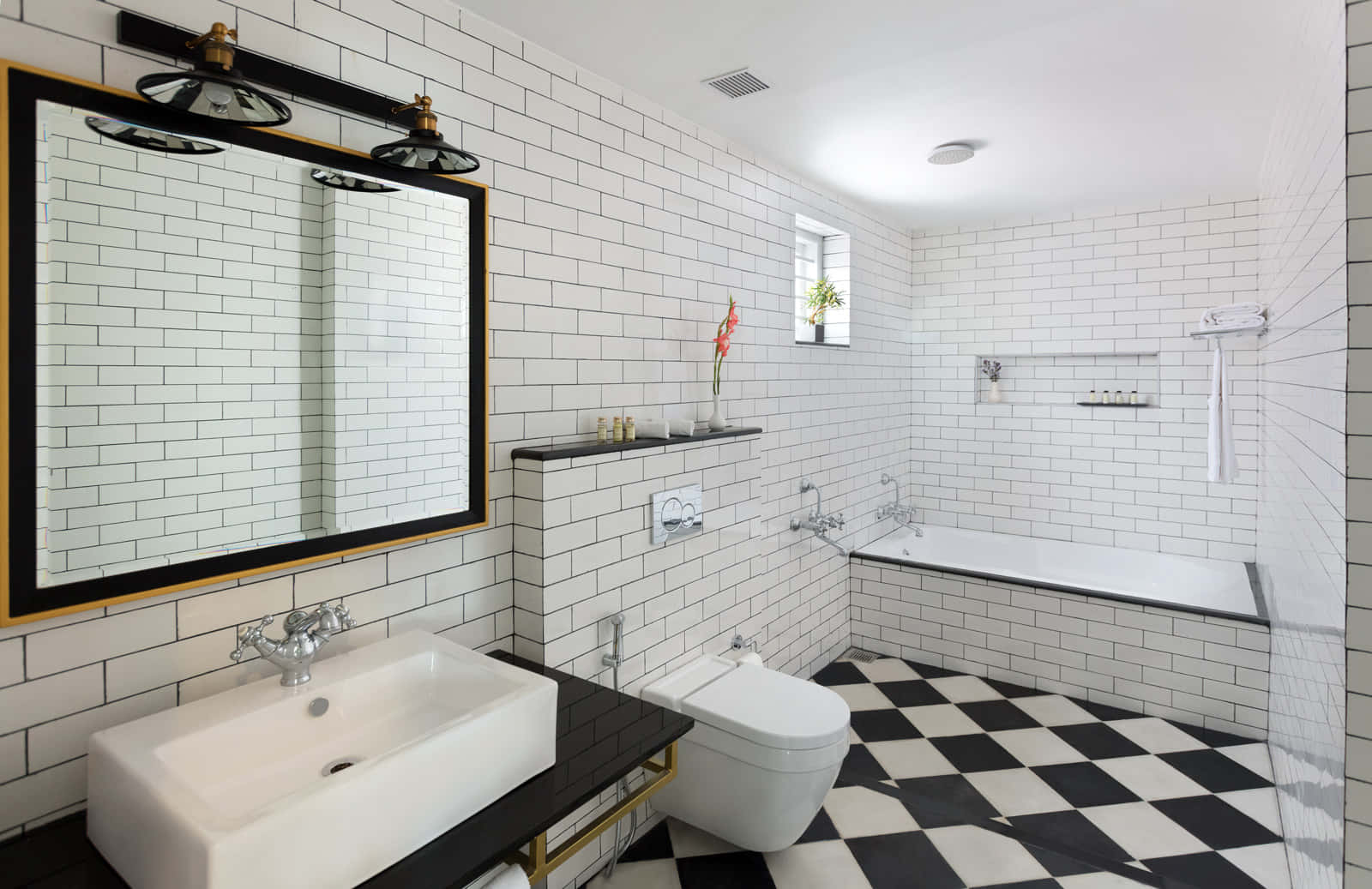 A Bathroom With A Black And White Checkered Floor