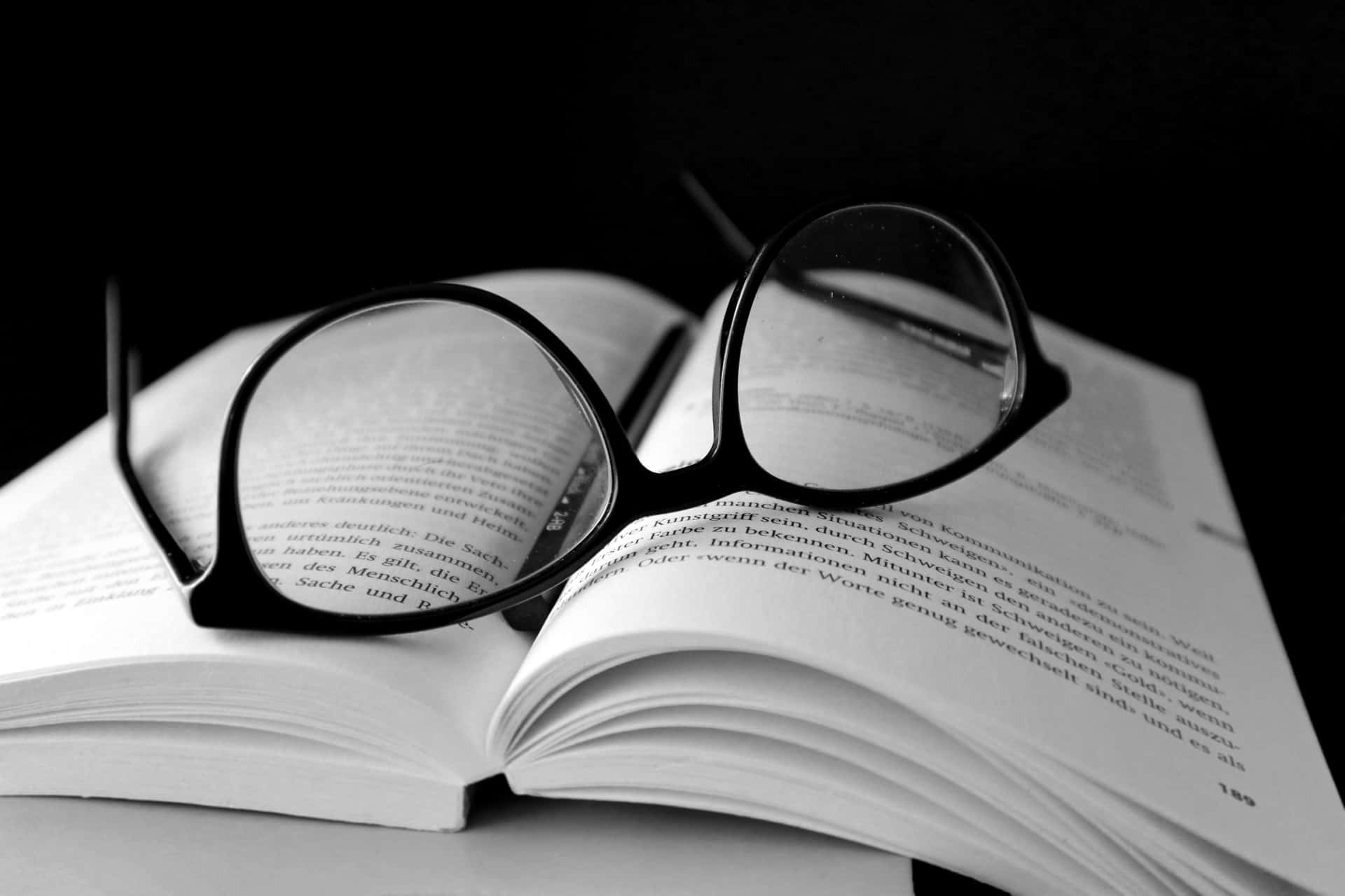 A captivating black and white close-up of an open book Wallpaper