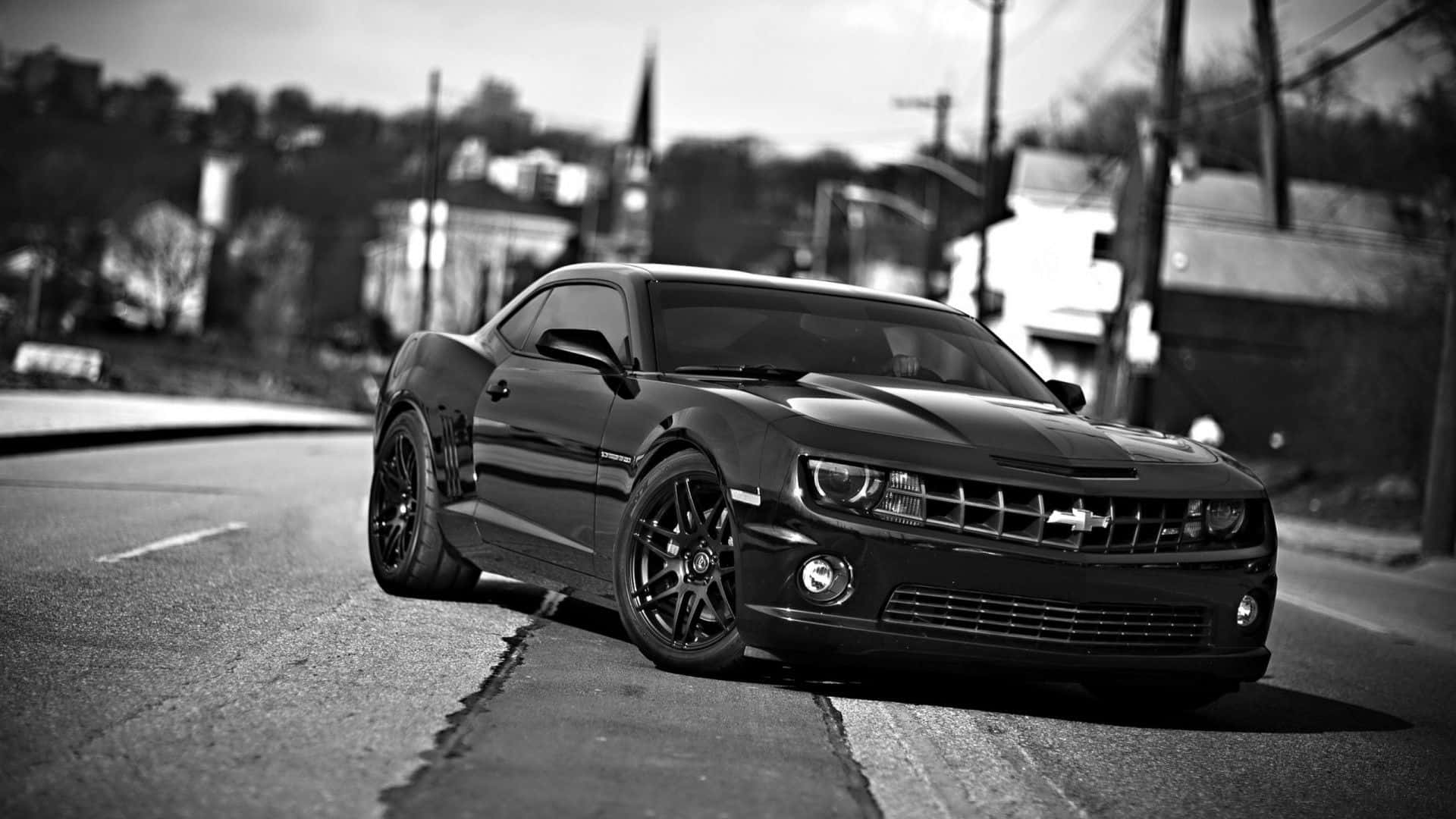 Sleek Black and White Car on City Streets Wallpaper