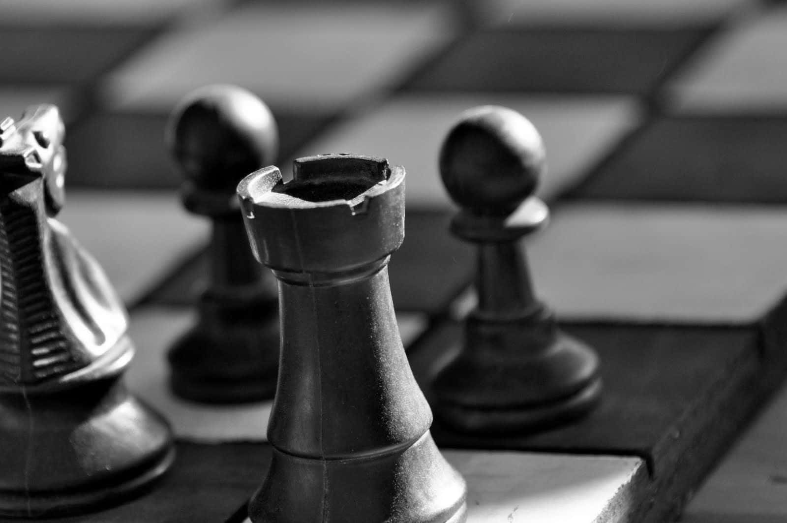 Black and White Chess Battle on Classic Board Wallpaper