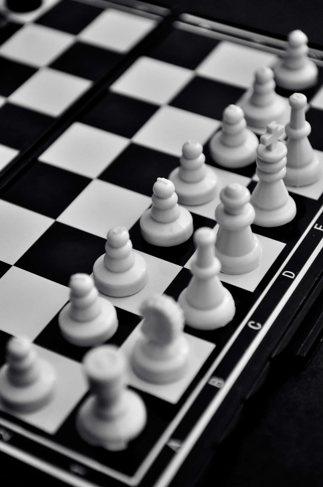 Intense Battle on a Black and White Chessboard Wallpaper