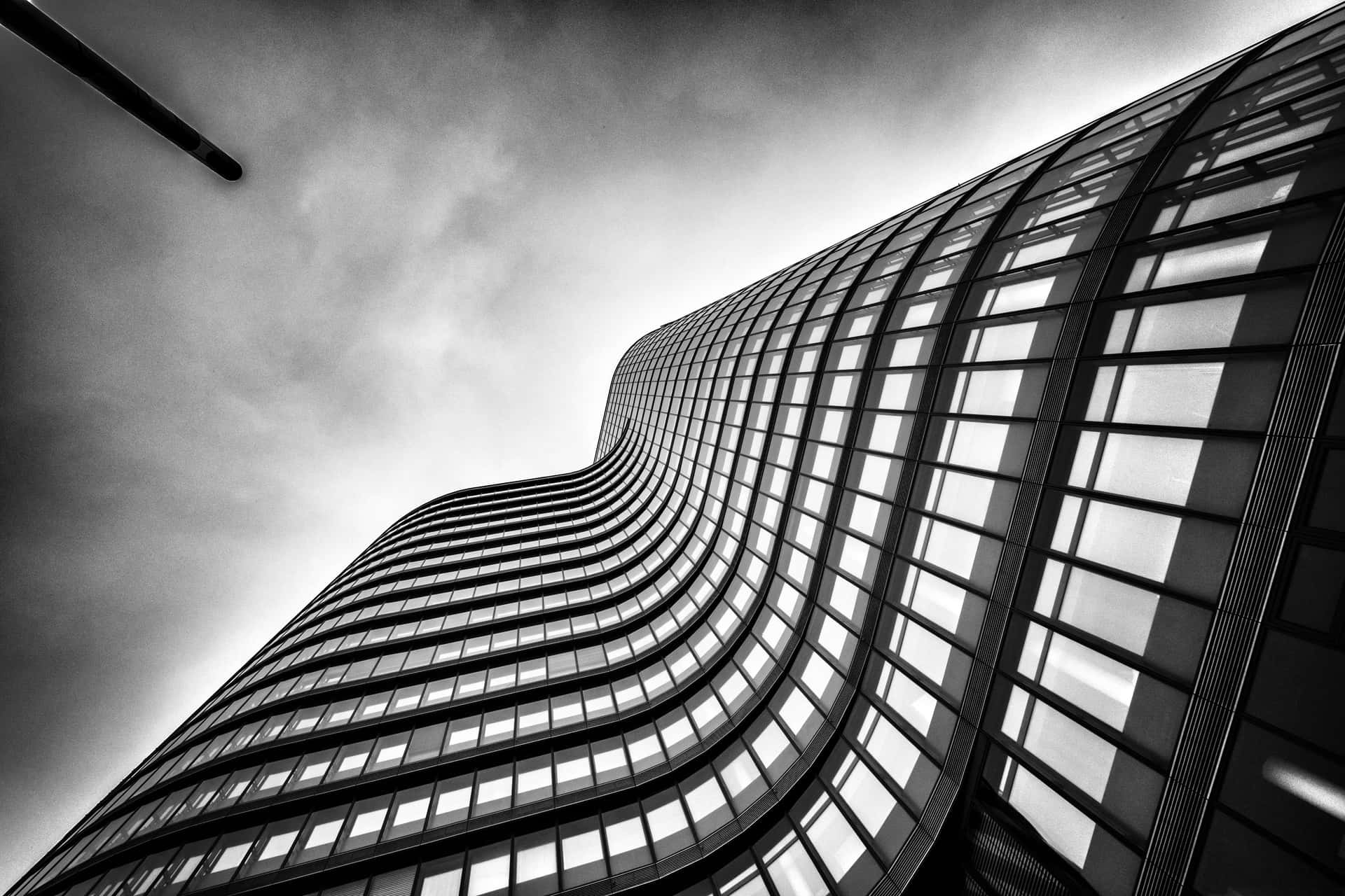 A Black And White Photo Of A Tall Building Wallpaper
