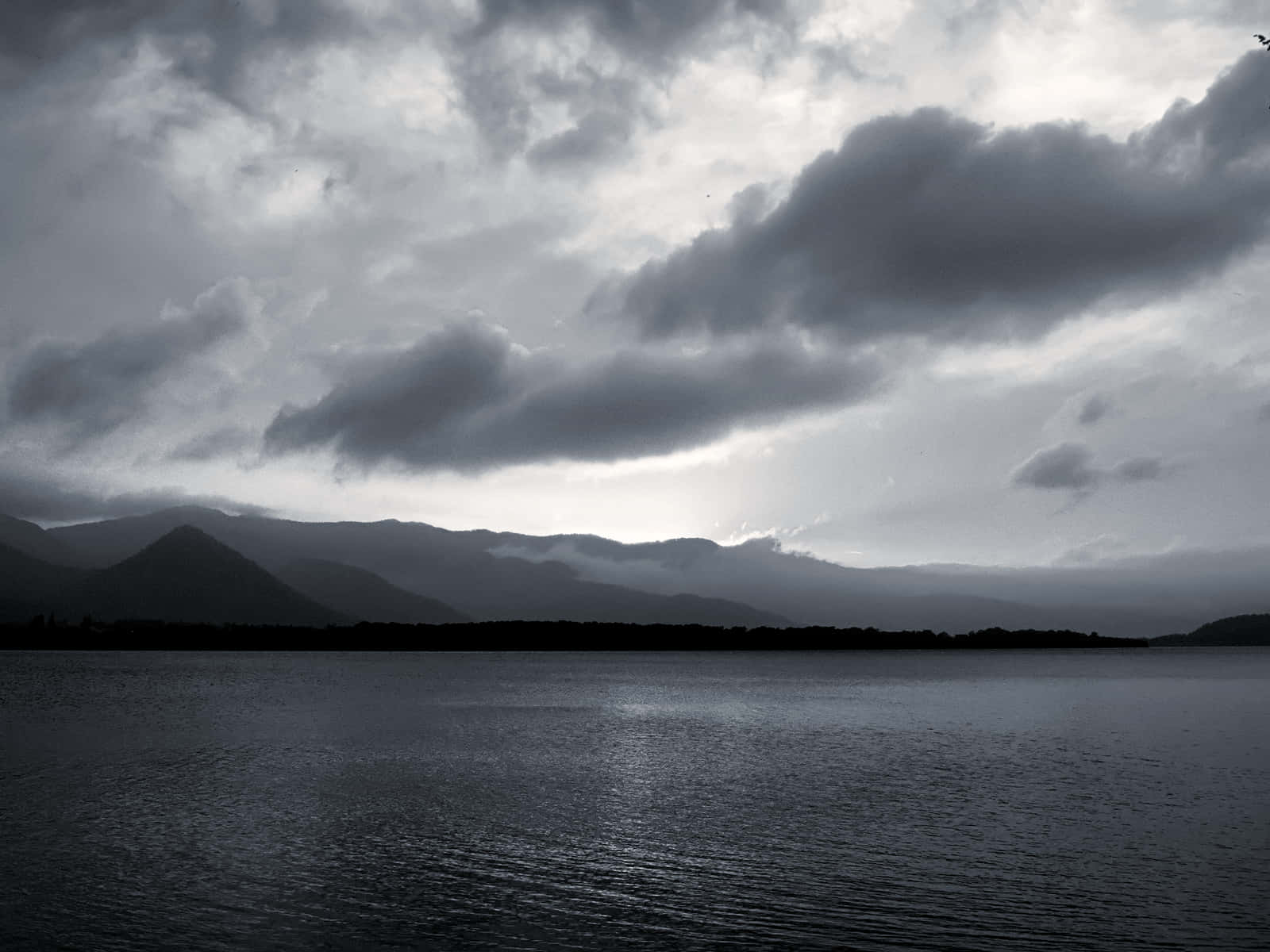 Picture of a black and white sky with billowy clouds Wallpaper
