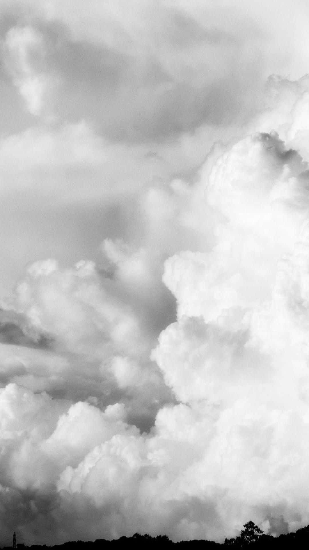 A Black And White Photo Of A Cloudy Sky Wallpaper