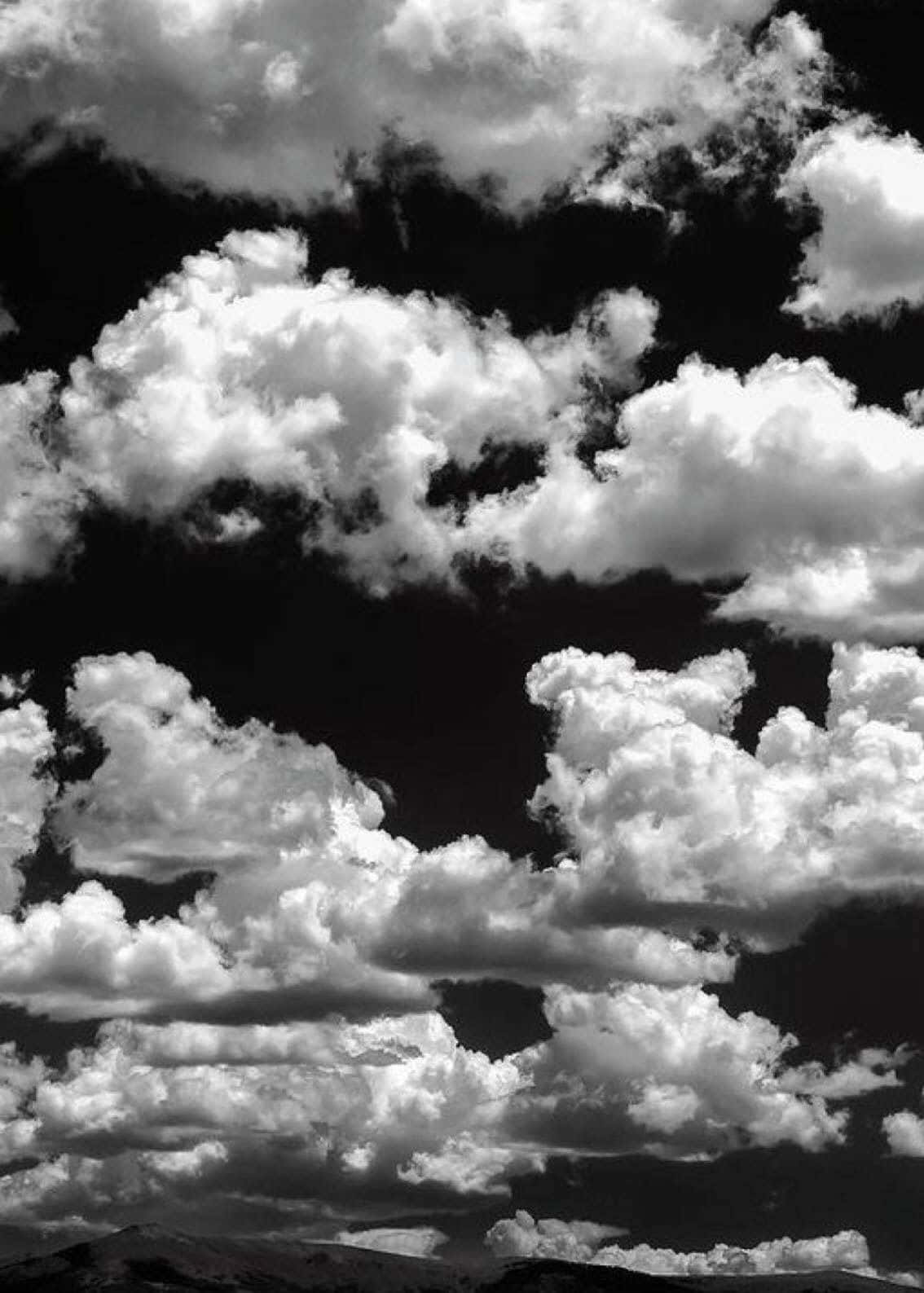 Enjoy the thunderstorm with the beautiful Black and White Clouds Wallpaper