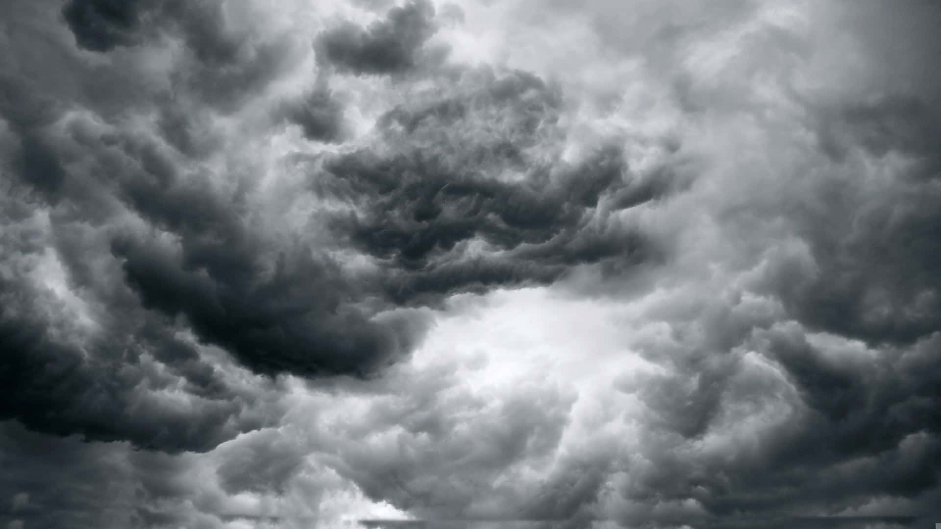 "A dramatic contrast of black and white clouds in the sky" Wallpaper