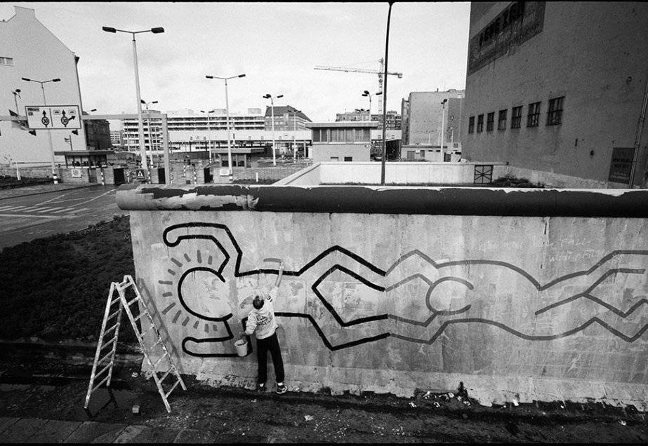 Graffitipreto E Branco De Keith Haring Trabalhando Em Uma Parede. Papel de Parede