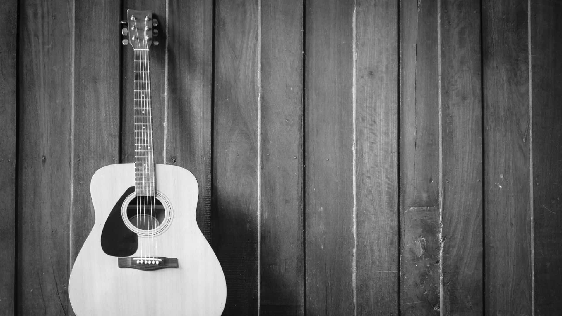 Black and White Acoustic Guitar on a Grayscale Background Wallpaper