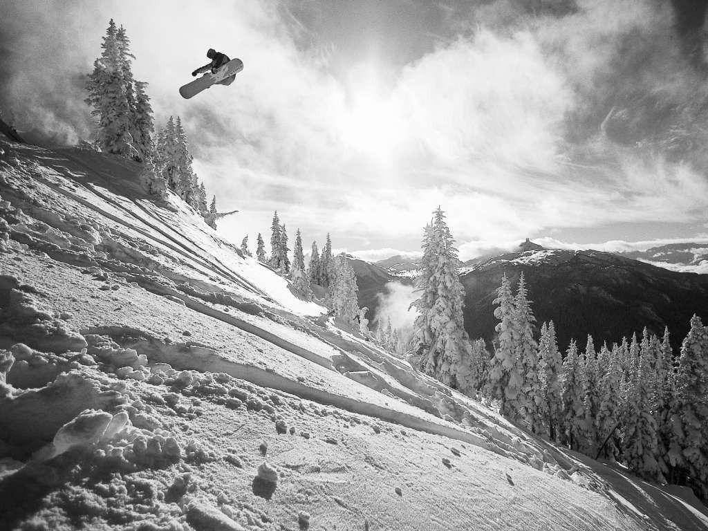 Black And White Man With Snowboard Down Slope Background