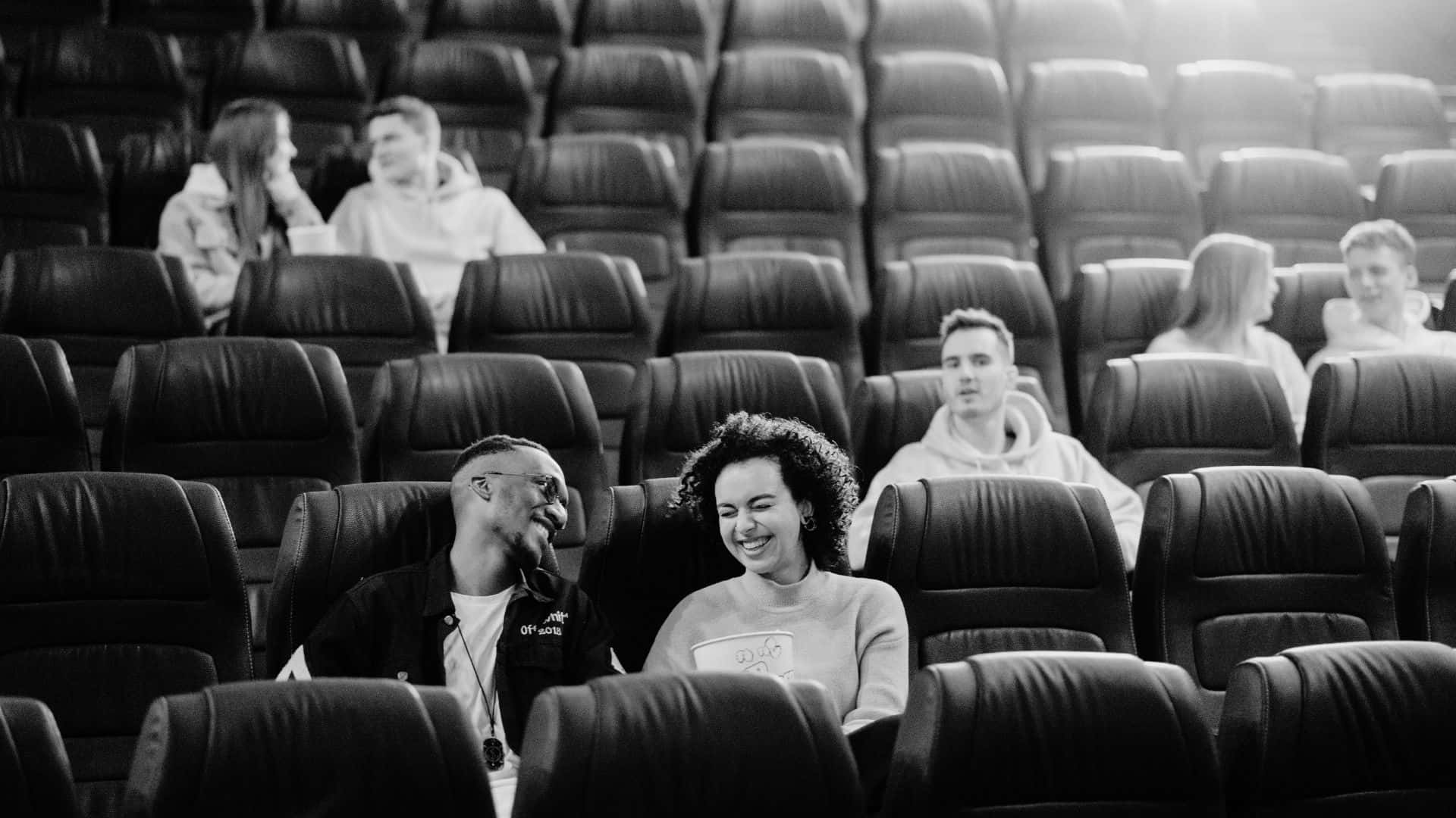 Classic black and white movie scene in a film theater Wallpaper
