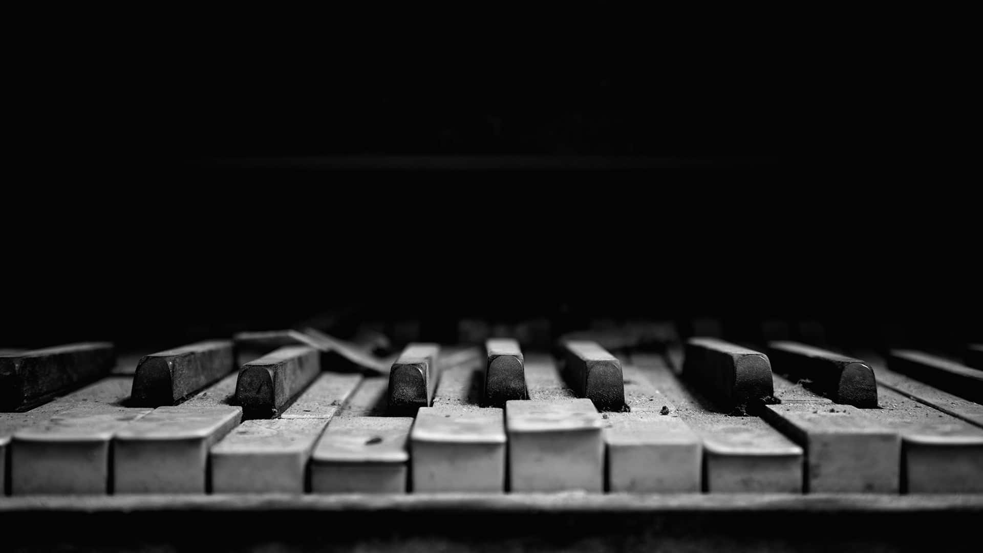 A captivating close-up of a piano keyboard in black and white Wallpaper