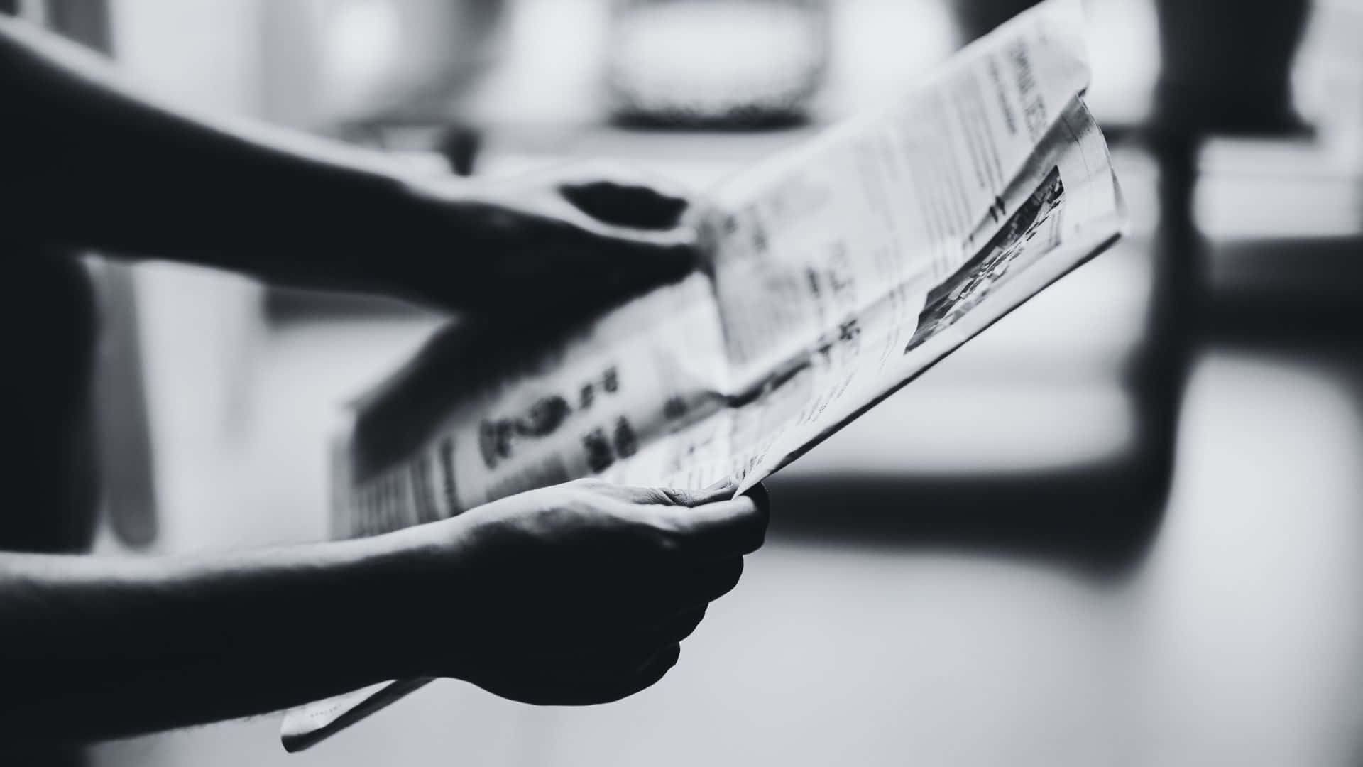 Vintage Black and White Newspaper on Table Wallpaper