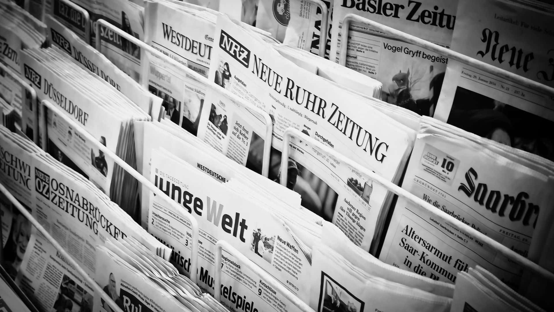 Vintage black and white newspaper displaying various articles and advertisements Wallpaper