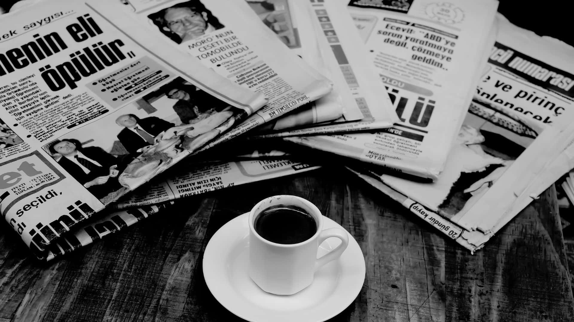 Vintage black and white newspaper on a table Wallpaper