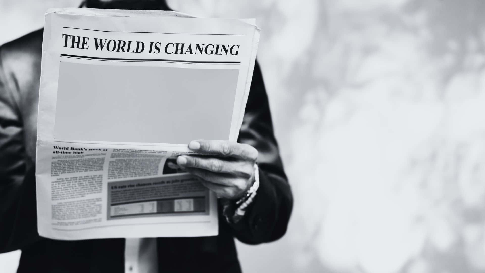 Vintage black and white newspaper against brick wall Wallpaper