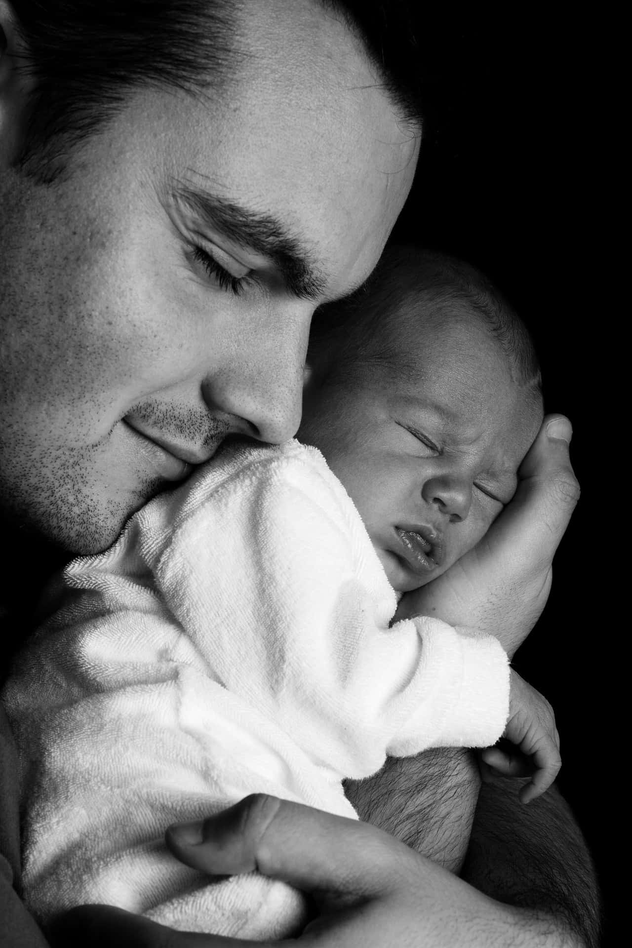 Black And White Photo Of A Father Holding A Newborn Baby Tangible Love Of A Father Wallpaper