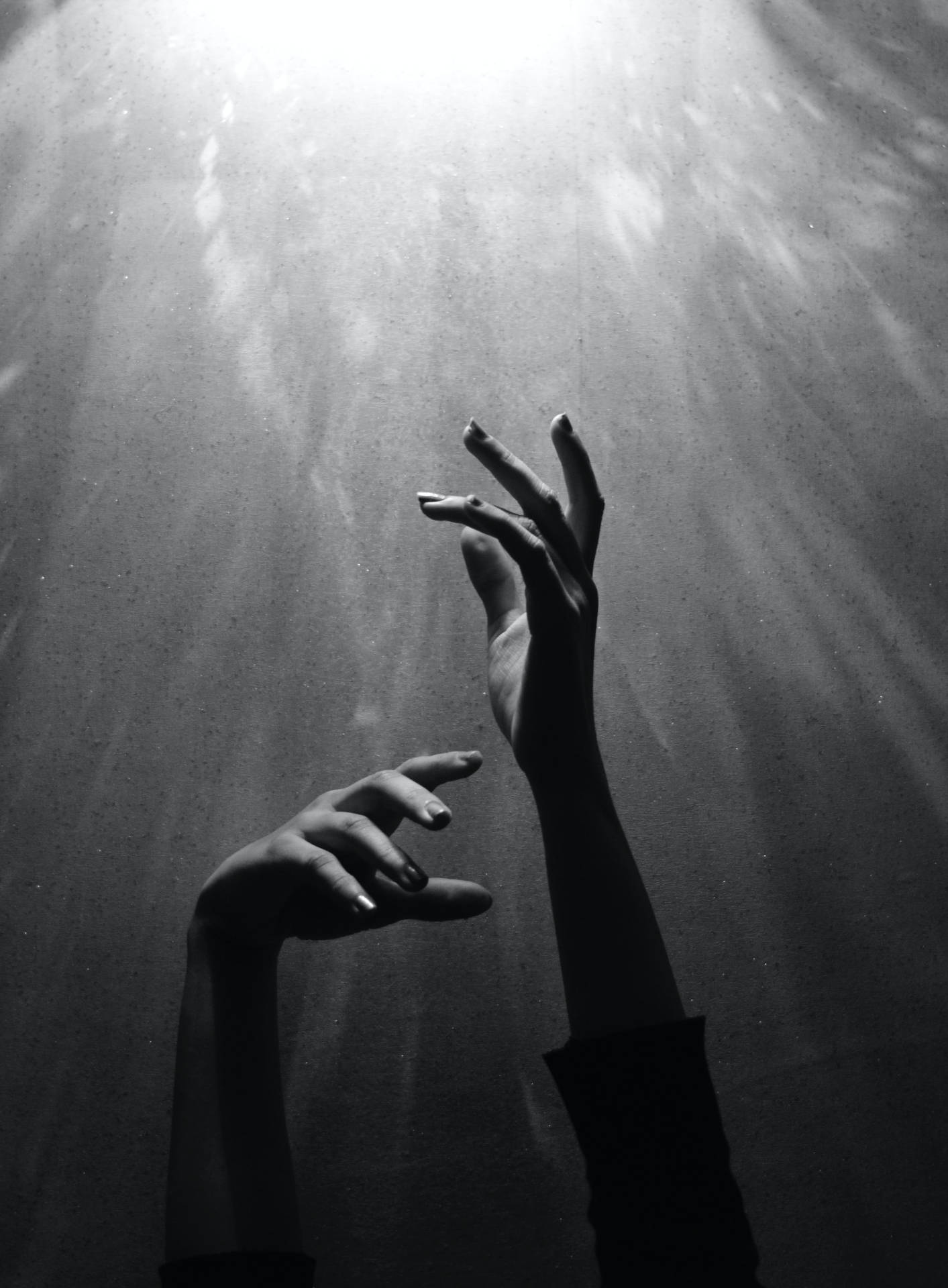 Black And White Portrait Of Hands Reaching For The Light Wallpaper